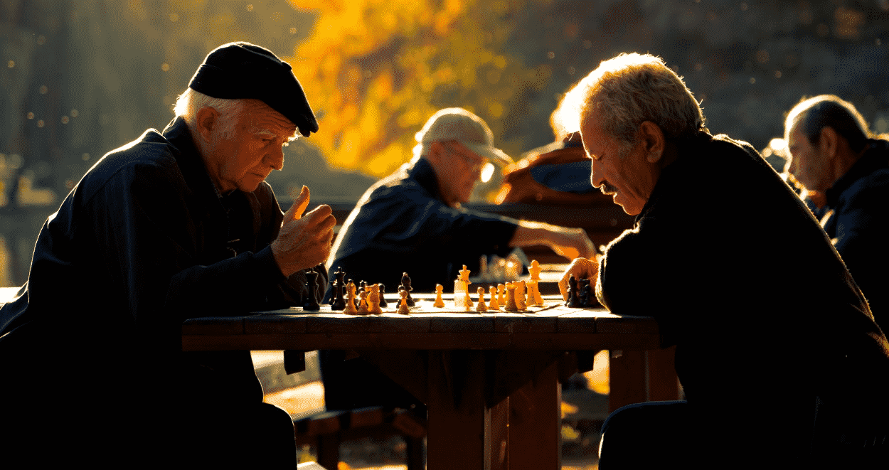Two Elderly gentleman playing chess and learning about assisted living lingo