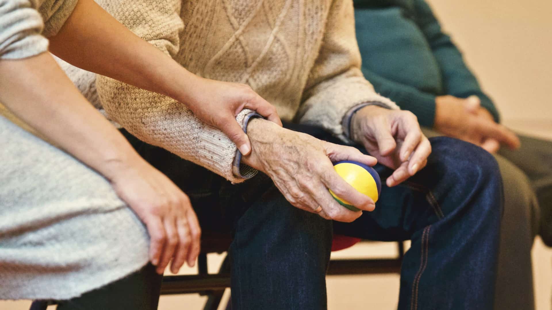 An Assistant helping an elderly woman