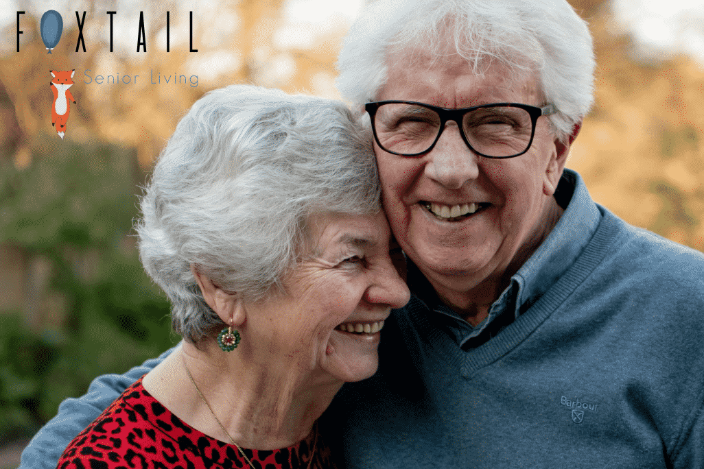A happy senior couple hugging each other in a park