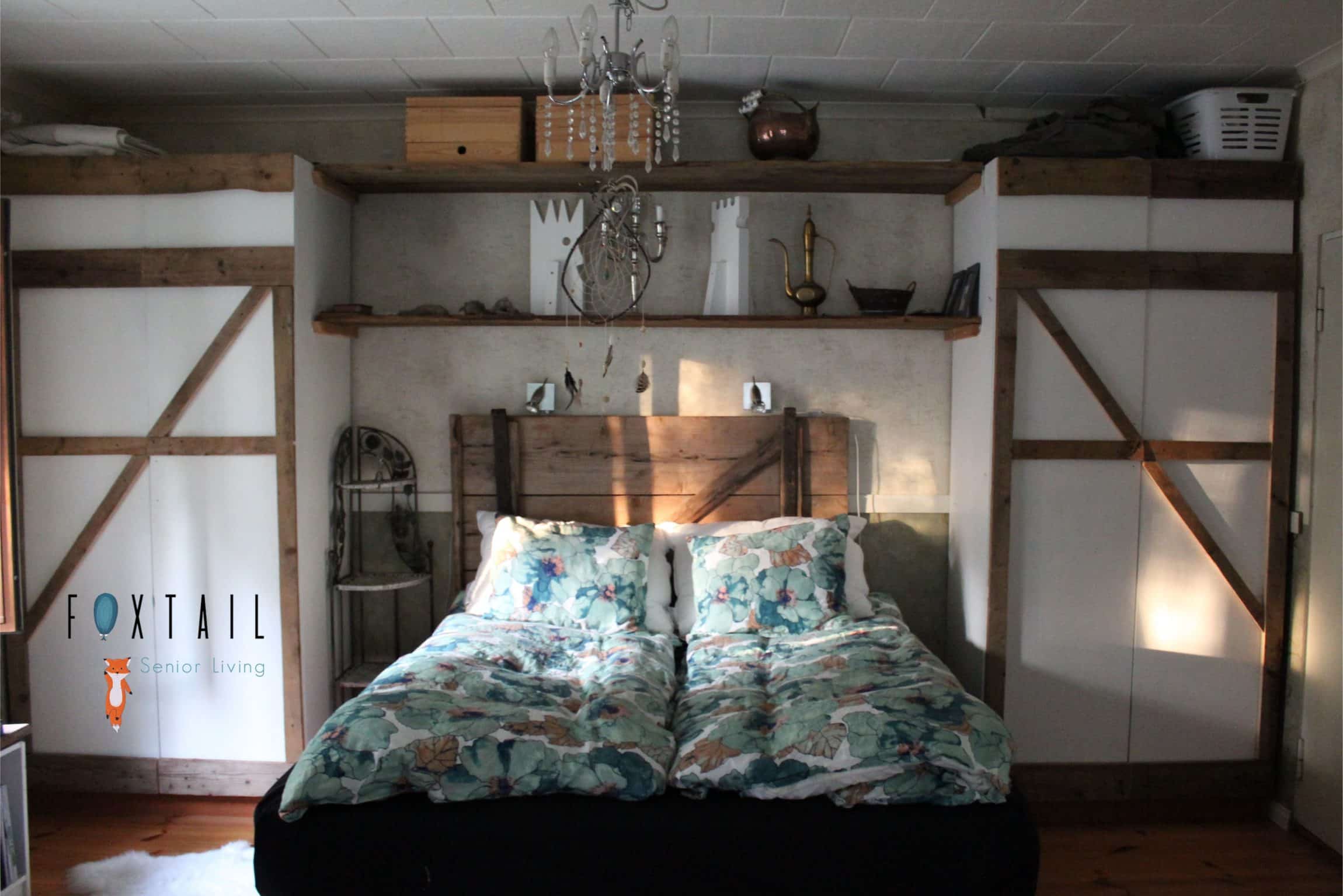 Bedroom with wood accents and colorful bed covers.