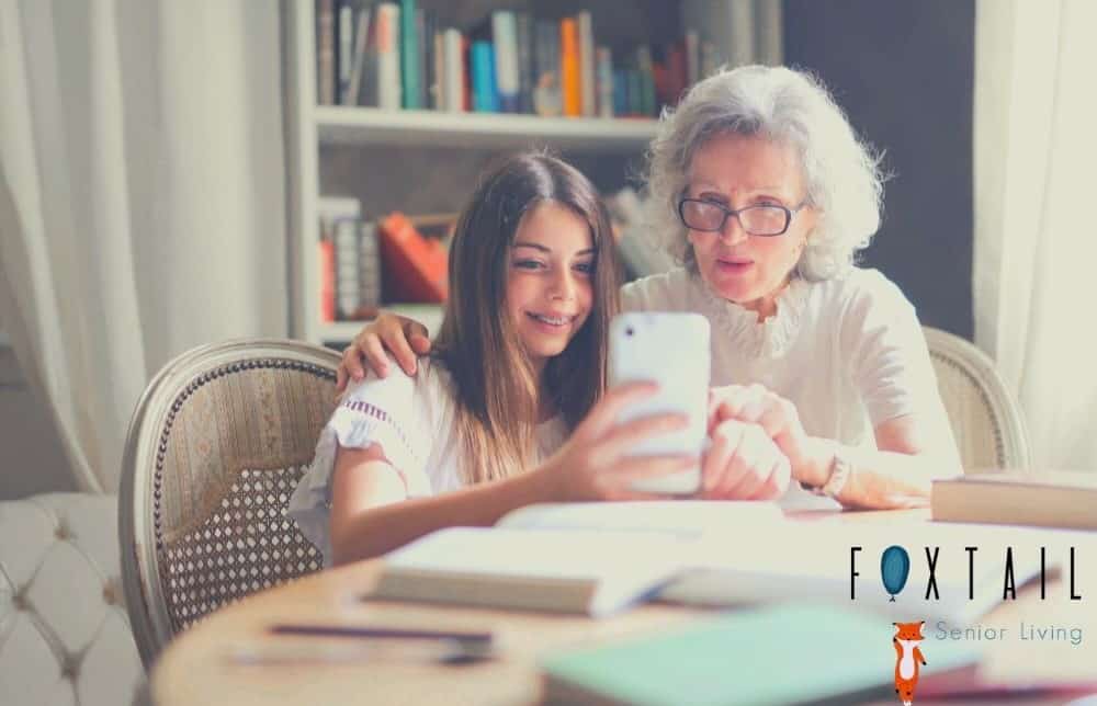 Grandchild showing her grandma a cellphone